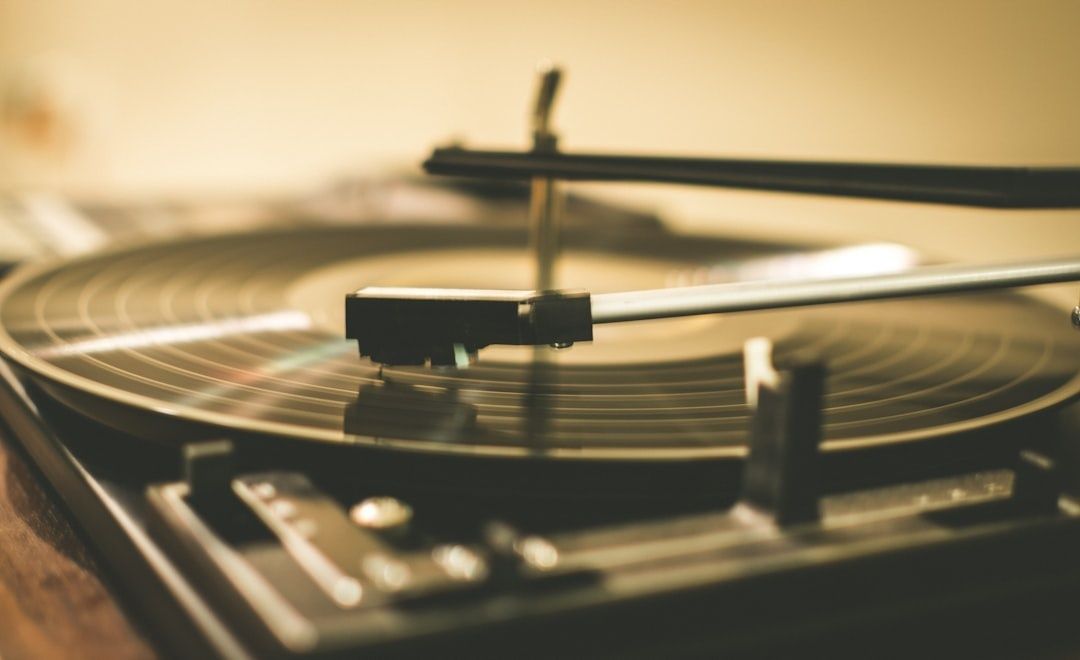 Närbild av skivspelare med pickup och nål över en snurrande vinylskiva